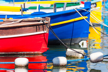 NICE, FRANCE:  detail of colorful “pointu” traditional wooden boats in "Port Lympia", the name of the city is also the name of the boat, French Riviera of Mediterranean Sea
