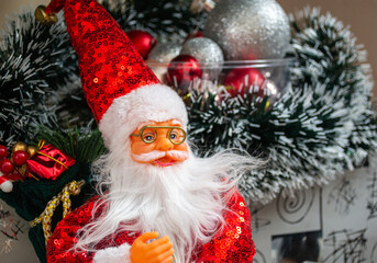 Merry Christmas and Happy New Year 2025. Toy Santa Claus and gifts.