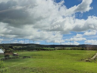 Highland Landscape with Cumulus Clouds and Wind Farms