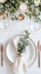 Set against a light background, white plates are arranged with a simple cloth napkin and fresh herbs, creating a chic and inviting atmosphere for a dining occasion