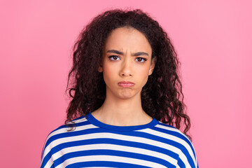 Portrait of nice young girl sullen face wear striped pullover isolated on pink color background