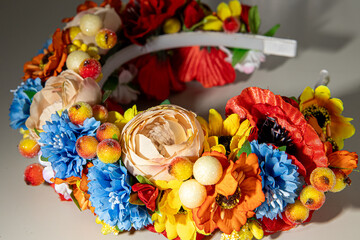 wreath of artificial colorful flowers and berries