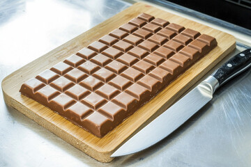Chocolate bar on a wooden board ready for serving