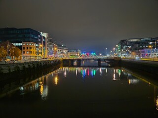 Fototapeta premium Cityscape at Dusk with Water, Sky, and Tower Block Reflections