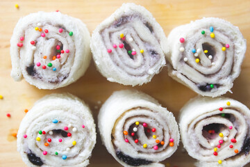 closeup of some homemade fairy bread served on a cutting board as a snack.