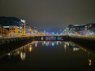 Fototapeta premium Cityscape at Dusk with Tower Blocks and Bridge Over Lake