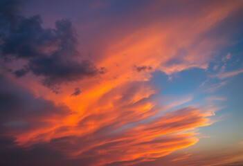 Fototapeta premium Dramatic cloudy sky with vibrant orange and blue colors at sunset