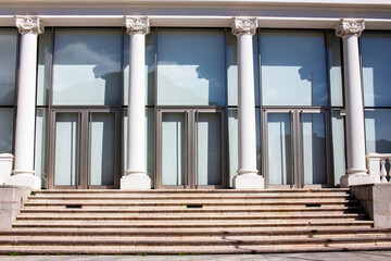 Architectural detail of a modern building with columns and glass windows