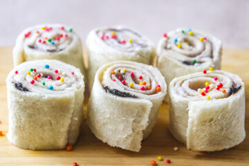 closeup of some homemade fairy bread served on a cutting board as a snack.