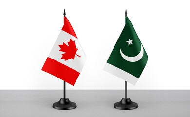 Image of the table flag of Canada and Pakistan countries. White background. Close-up flags. High...
