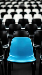 Fototapeta premium Lone blue stadium seat among blackandwhite rows