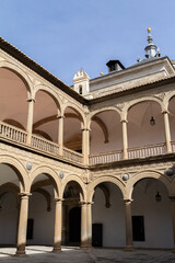 Obraz premium Elegant columns of the Hospital de Tavera in Toledo, Spain, showcasing Renaissance architecture with intricate detailing and classical style. 