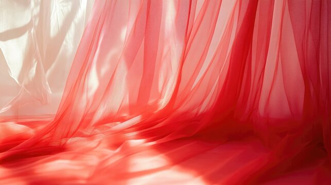 Elegant red tulle drapery creating soft shadows and textures in a close-up view suitable for backgrounds and fashion displays.