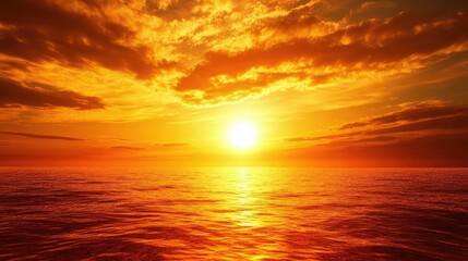 Obraz premium Serene sunset over tranquil sea with vibrant orange hues and dramatic clouds during golden hour creating a picturesque nature scene