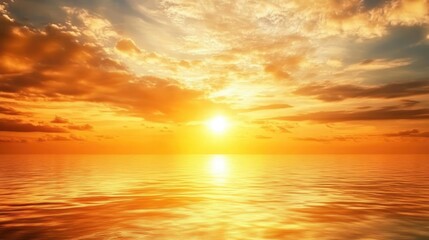 Obraz premium Serene sunset over calm sea with vibrant orange and yellow hues reflecting on water, creating a stunning autumn evening landscape.