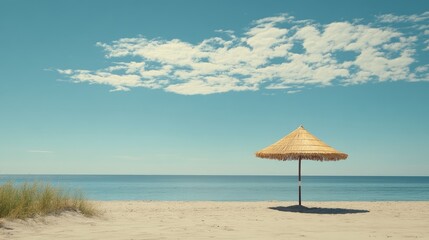 Fototapeta premium Rattan beach parasol on a tranquil shoreline serene ocean backdrop under a clear blue sky ideal for summer getaways and relaxation
