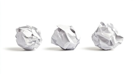 Crumpled paper balls arranged on a clean white background symbolizing waste creativity and discarded ideas