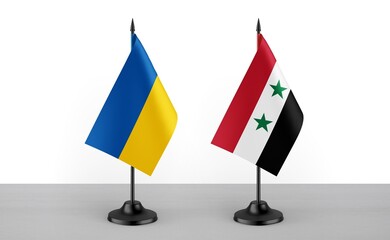 Image of the table flag of Ukraine and Syria countries. White background. Close-up flags. High...