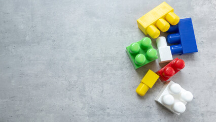 Colorful Plastic Building Blocks on Gray Surface