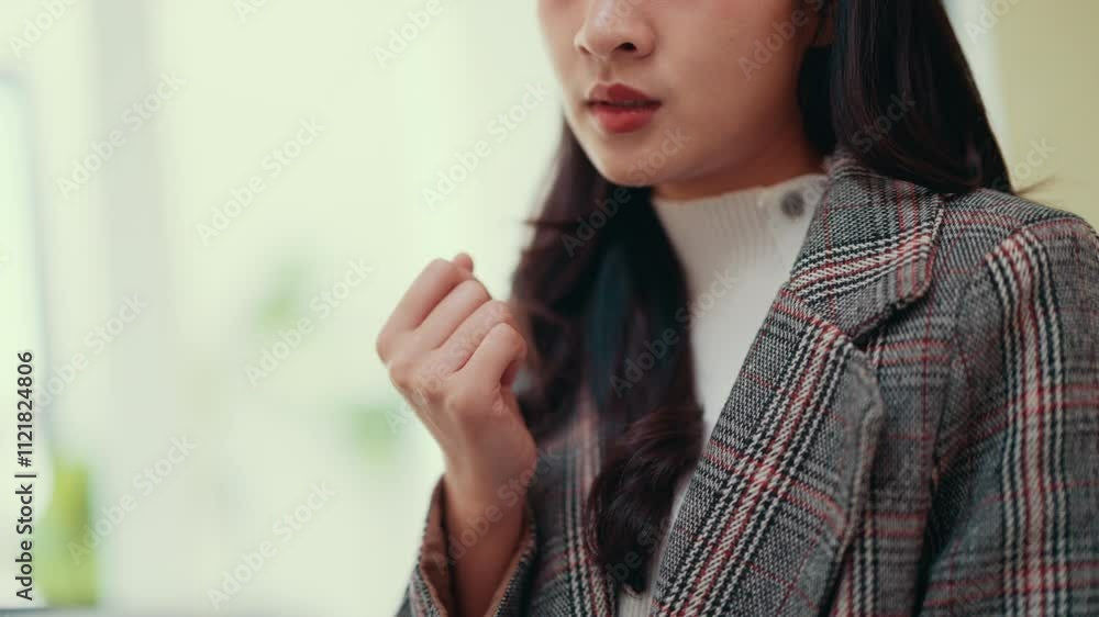 Poster young businesswoman concentrates while using a laptop. engaged in typing and thinking, she works dil