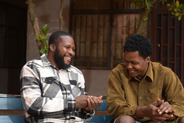two handsome african feeling excited about what they saw on their cellphone