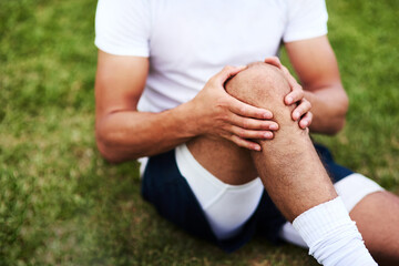 Man, knee injury and athlete on field, joint pain and emergency accident at sports competition....