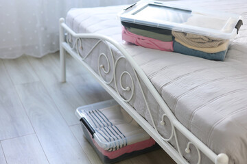 Effectively Organizing and Storing Clothes Under the Bed Using Clear Storage Boxes for Clarity
