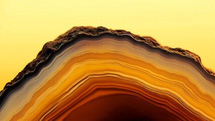 Close-up photograph of a slice of agate placed on a soft yellow background. The focus is on the texture and natural beauty of the stone in a minimalist composition.