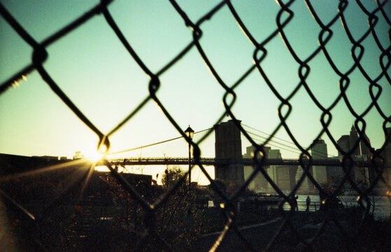 sunlight shinning through a fence with barbed wire, Brooklyn, New York City 