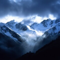 Obraz premium Snowy Peaks with Layers of Mist and Cloudy Sky Snow Covered Mountains and Peaks, Winter season, Happy New Year, Happy Christmas 