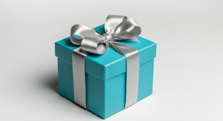 Obraz premium A teal gift box with a silver ribbon and bow.