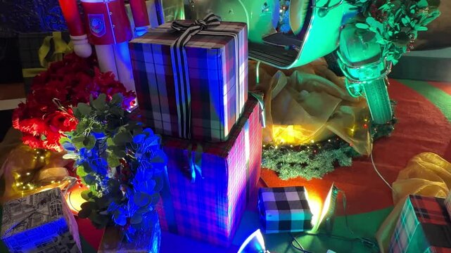 4k footage of christmas decoration of gift boxes, presents, candy cane, teddy bear, hampers, and other kids gift stuffs with wreathes and twinkle or icicle lights.