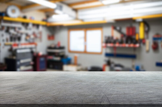 Scratched steel table top and service shop background
