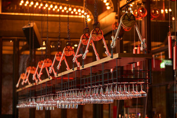 Showcase elegant hanging glassware in a modern bar setting. Perfect for bars, restaurants, and home...