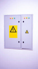 Electrical control panel with warning signs and indicator lights, designed for safety and...