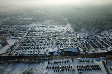Aerial view of many cars parked for sale and people customers walking on car market or parking lot...
