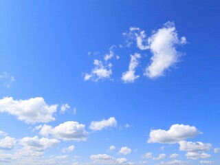 Obraz premium Fluffy white clouds on bright blue sky, perfect weather for summer outdoor activities, scenic, serene