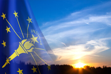 Flag of Indiana against the sunset. U.S. state
