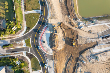 Roadworks construction site at roundabout intersection on American highway. Development of city...