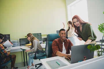 Photo of young age company junior sales managers colleagues using computers research consumers...