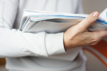 Young womans hands holding notebooks and textbooks, close up