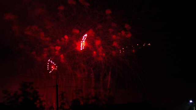 Silver lilac pink sparks scattering fireworks on the black night sky. General plan