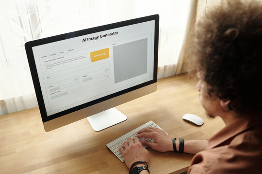 Focus on screen of desktop computer with visual language model and hands of young man typing on keypad