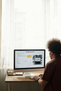 Focus on screen of desktop computer with AI image generator and young creative man generating new content