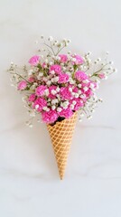 A waffle cone beautifully arranged with soft pink flowers and lush baby's breath rests on a white marble surface, creating a serene and minimal aesthetic perfect for floral enthusiasts