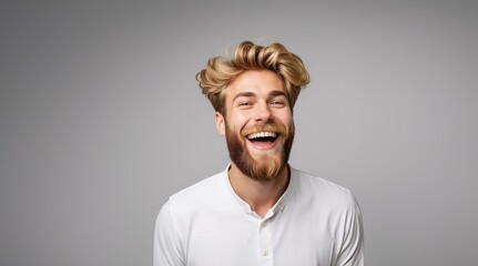 Obraz premium Positive and joyful Man laughing. Happy smiling young beauty man laughing. Portrait Of Young Handsome Man Smiling. Closeup face of smiling casual man. Happy male model.