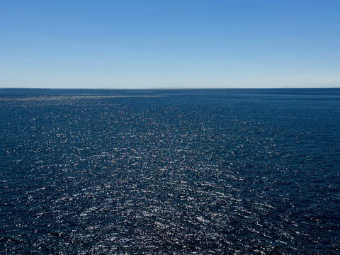 Blue twinkling sea water and blue sky. 