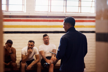 Men, coach and meeting with sports team in locker room for discussion, game plan or formation. Male...