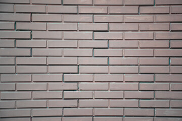 Obraz premium Modern Brick Wall with Unique Geometric Pattern - Close-up of a Minimalist Textured Surface Featuring Stylish Brown Tones and Creative Design for Architectural Backgrounds, Urban Themes, and Interior 
