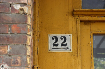 Fototapeta premium Number 22 on old yellow door